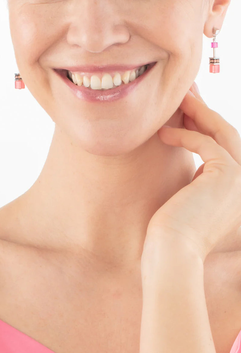 The Coeur De Lion GeoCube Viva Magenta Earrings, a magenta stainless steel earrings from Coeur De Lion, available at OD’s Jewellers in St Helens.