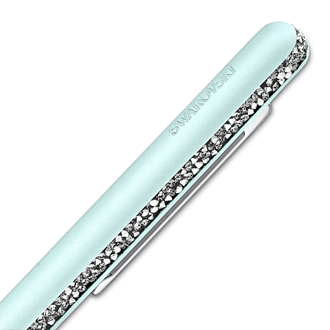 Close-up of a light blue Swarovski ballpoint pen with a crystal band detail, showcasing craftsmanship. SWAROVSKI is on the