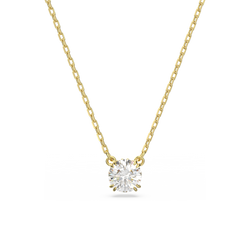 Constella pendant necklace: gold plated chain showcasing a brilliant round cut Swarovski crystal. Elegant jewelry.