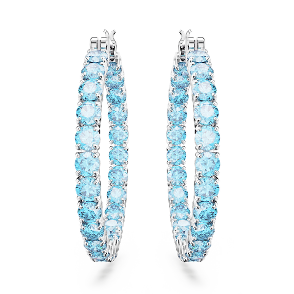Swarovski Matrix hoop earrings with blue crystals and rhodium plating. Jewelry product close-up.