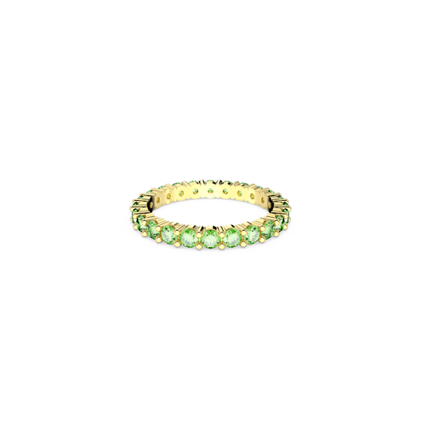 Swarovski Matrix ring, a close-up showcases the gold-plated band with round-cut green crystals in an eternity design.