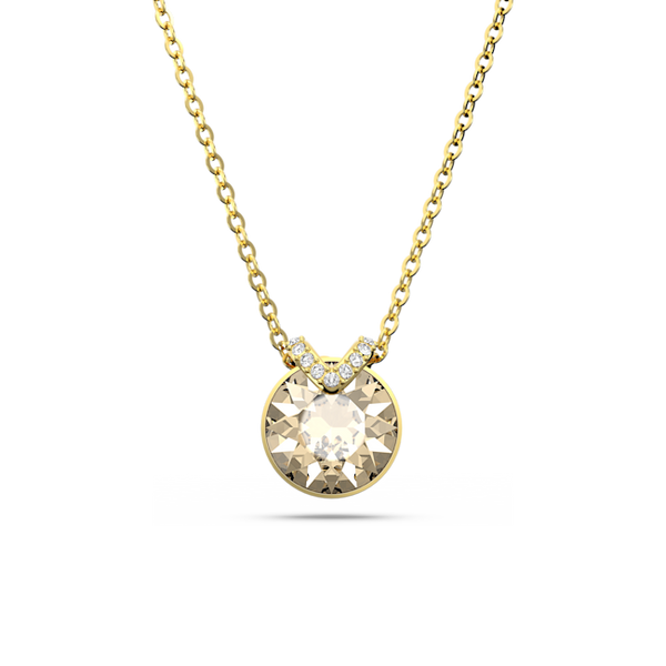 Close-up of a gold-plated Swarovski Bella V pendant necklace featuring a brilliant round crystal stone.
