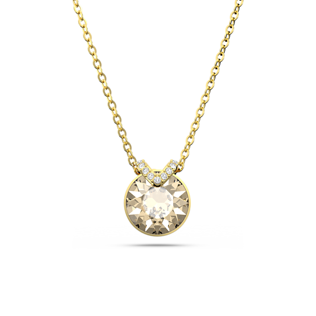 Close-up of a gold-plated Swarovski Bella V pendant necklace featuring a brilliant round crystal stone.