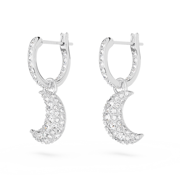 Close-up showcasing Swarovski Luna earrings, rhodium-plated hoops with crystal-paved crescent moon drops, a celestial