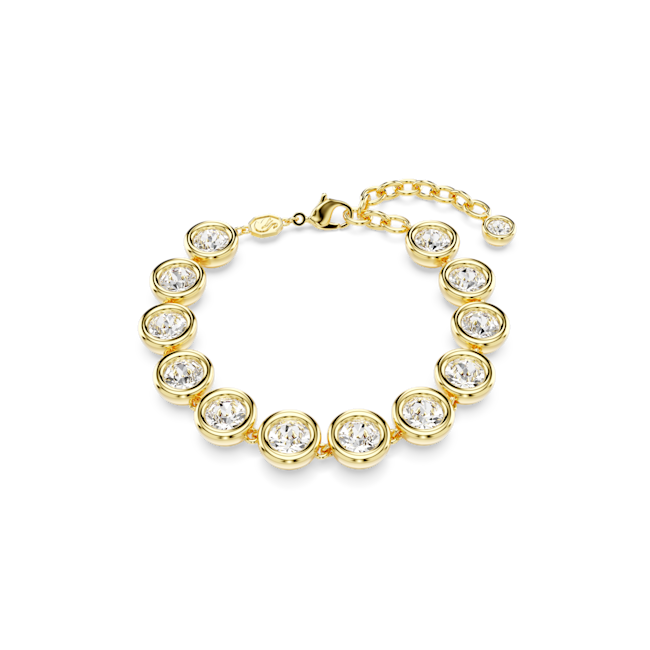 Gold plated Swarovski tennis bracelet showcasing round cut crystals in a bezel setting, highlighting its design & elegance.