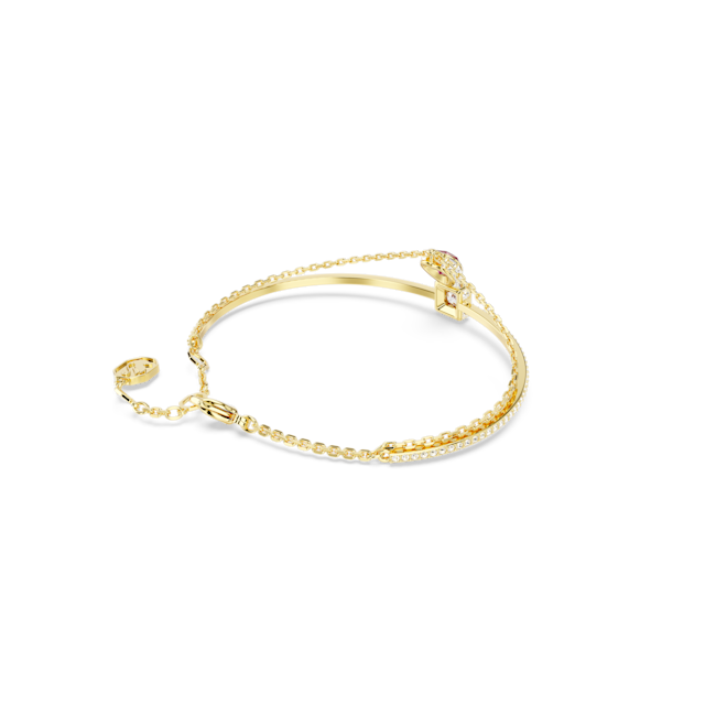 Gold plated Swarovski heart bangle adorned with red Stilla crystals, jewelry close-up showing delicate details.