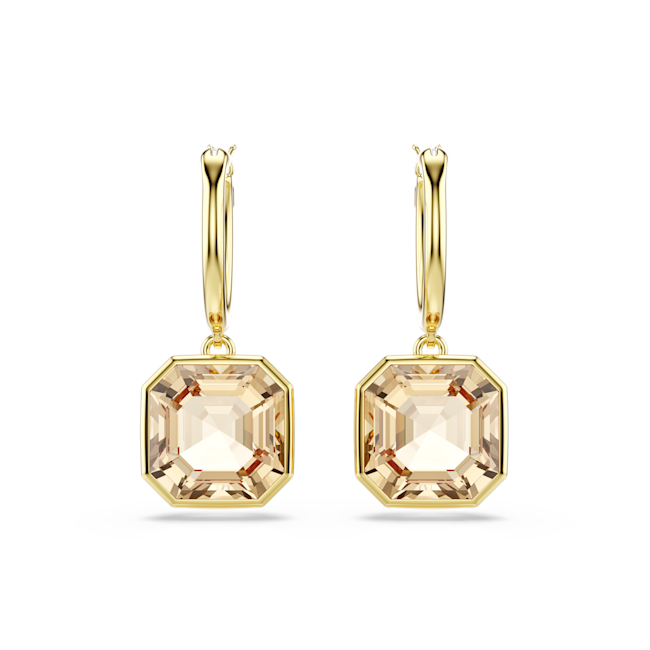 Close-up of Swarovski Millenia drop earrings featuring square-cut caramel crystals and gold-tone finish on a black
