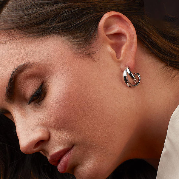 The Kit Heath Serenity Grande cross over semi hoop earrings, a silver sterling silver earrings from Kit Heath, available at OD’s Jewellers in St Helens