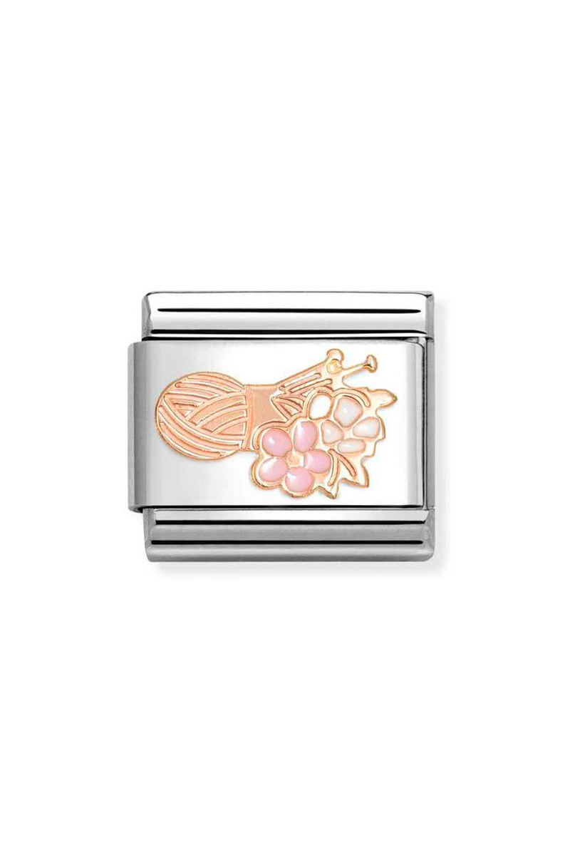 Square, silver charm featuring a pink yarn ball, knitting needles, and flowers.