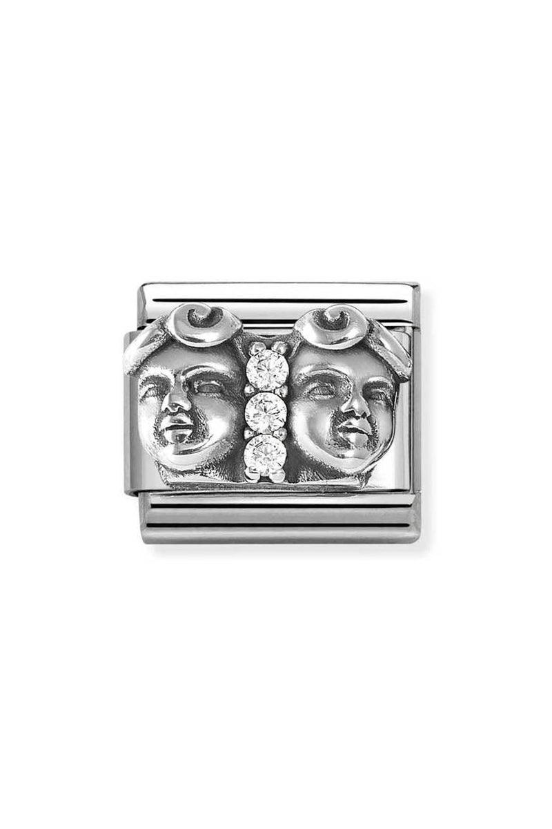 Silver charm with face details and embedded crystals.
