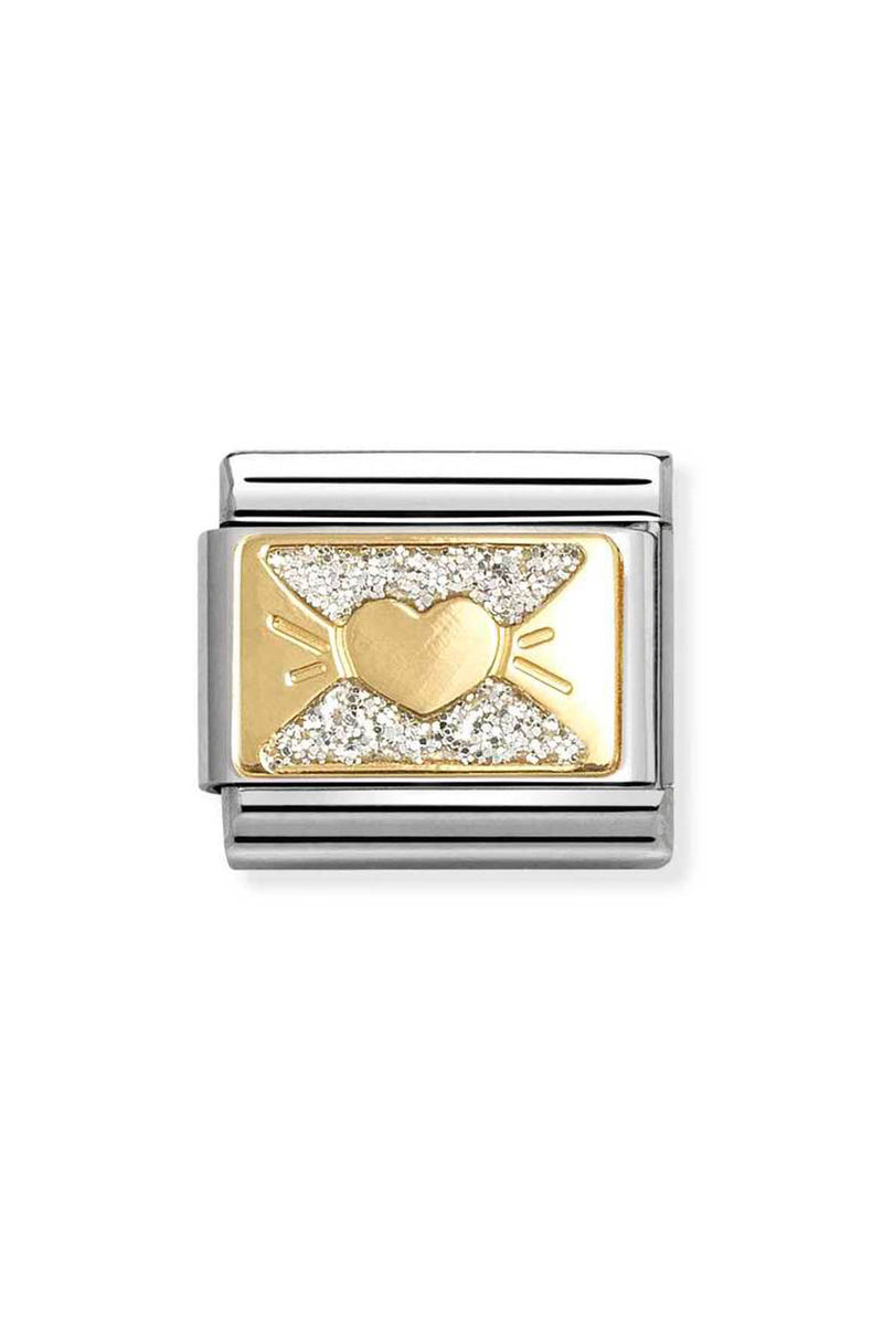 Close-up of a silver and gold charm with a heart.