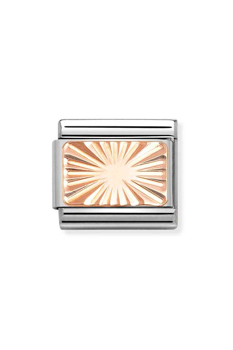 Close-up of a rectangular silver charm with a sunburst design.