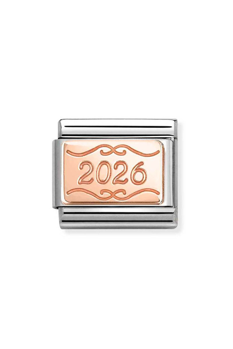 Close-up of a silver and rose gold charm with the number 2026.