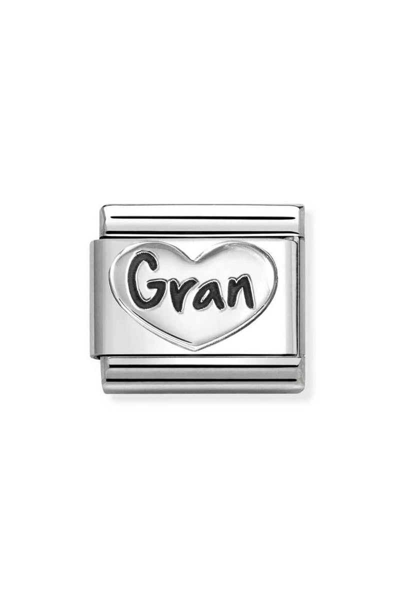 Close-up of a silver bracelet charm with the word "Gran" in black lettering inside of a heart.