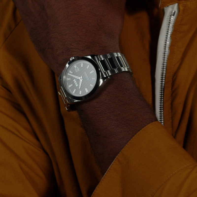 Close-up of BOSS Strike watch on wrist, showcasing the black lined dial and stainless steel design.