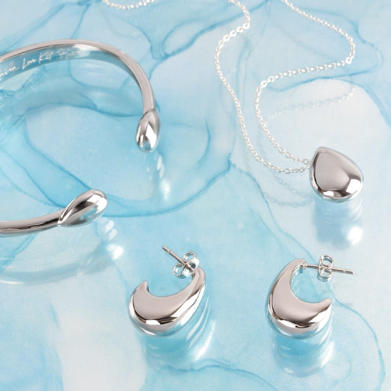 The Kit Heath Coast Pebble Smooth Hinged Bangle, a silver bracelet from Kit Heath, available at OD’s Jewellers in St Helens