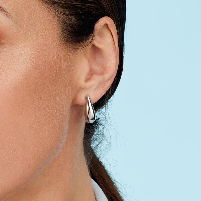 The Coast Pebble Smooth Grande Semi Hoop Stud Earrings, a silver metal earrings from Kit Heath, at OD’s Jewellers St Helens