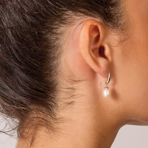 The Kit Heath Revival Classic Pearl Drop Earring, a white pearl silver earring from Kit Heath, available at OD’s Jewellers in St Helens