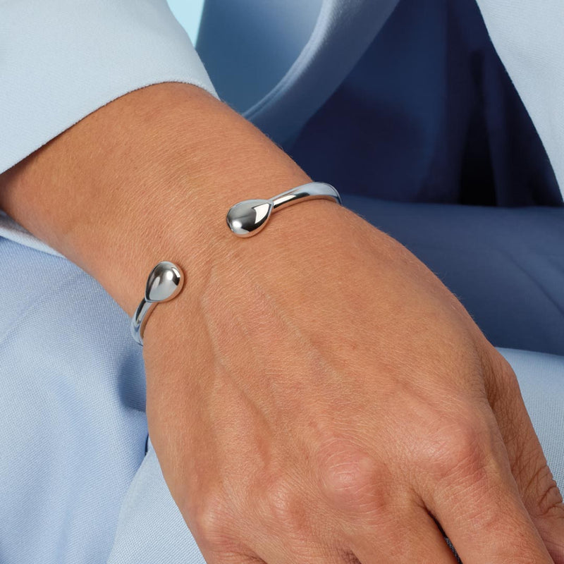 The Kit Heath Coast Pebble Smooth Hinged Bangle, a silver bracelet from Kit Heath, available at OD’s Jewellers in St Helens.