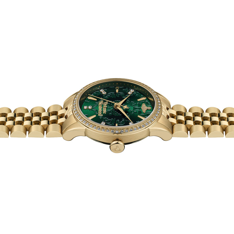 Close-up of the Vivienne Westwood Wallace watch. Highlights the gold plating, green dial, and jeweled accents.