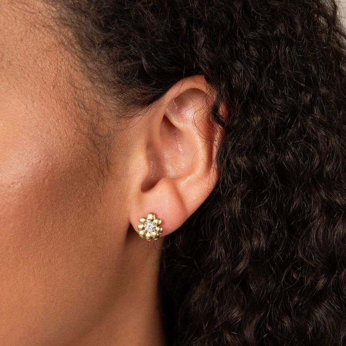 Close-up showcasing the Laura Ashley Cosmos flower stud earring. Its gold-plated design adds a touch of elegance to any look.